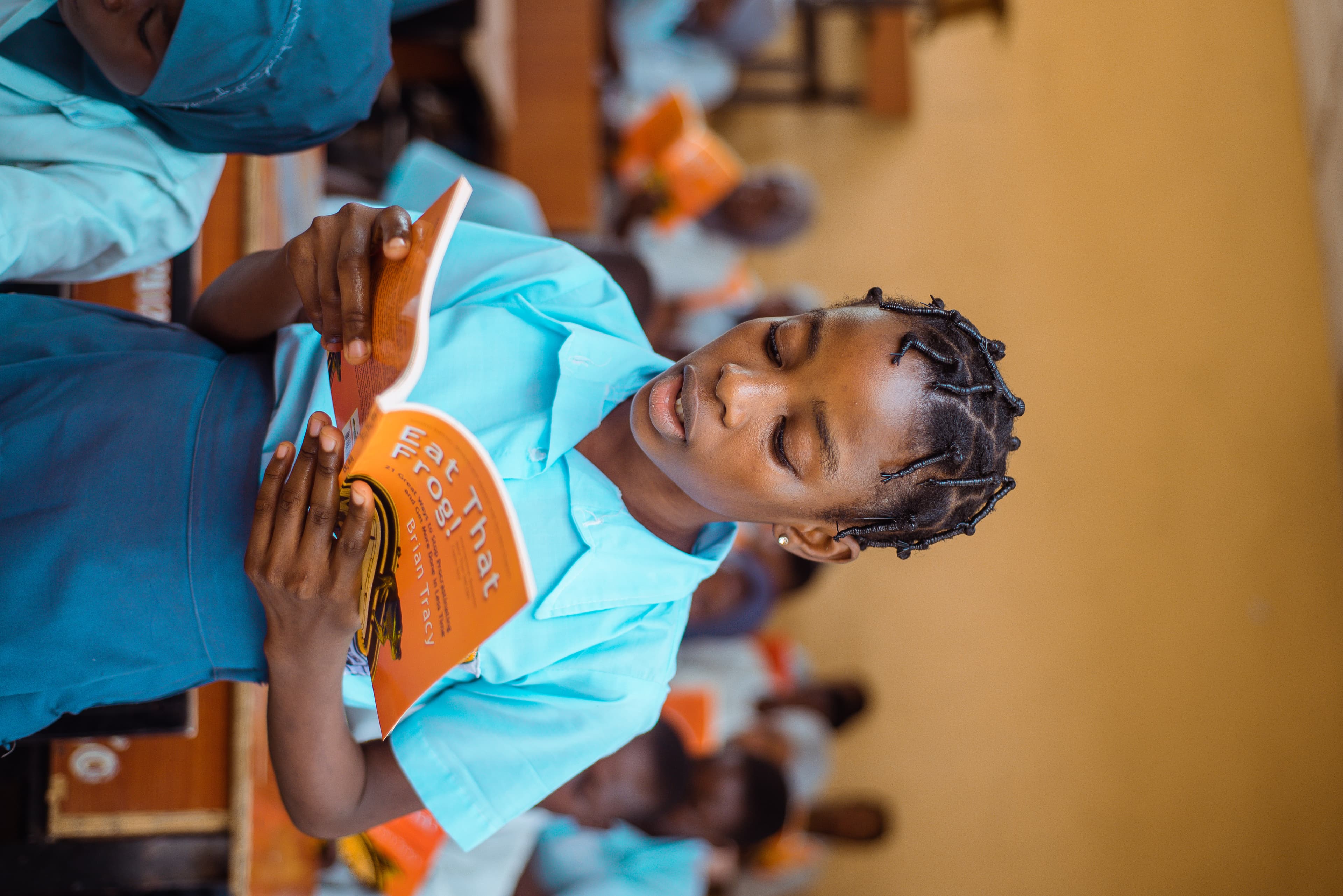 Student reading Eat That Frog in class